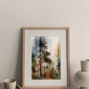 May include: A framed watercolor painting of a forest scene with trees in shades of brown, green, and blue. The painting is in a light wood frame and is sitting on a white surface.