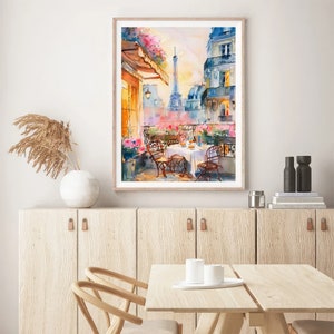 May include: A watercolor painting of a Parisian balcony scene with a view of the Eiffel Tower. The balcony has a table set for two with white chairs and a white tablecloth. There are flowers and greenery in pots on the balcony.