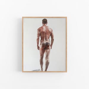 May include: Watercolor painting of a nude male figure from the back, standing with his feet slightly apart. The artwork features a light brown skin tone and is set against a white background, framed in a light wood.
