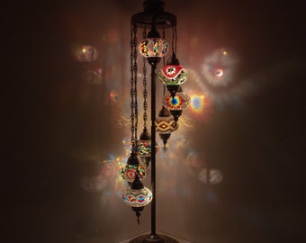 May include: A floor lamp with a curved metal stand and seven colorful mosaic glass globes. The globes are suspended from chains and have intricate patterns.
