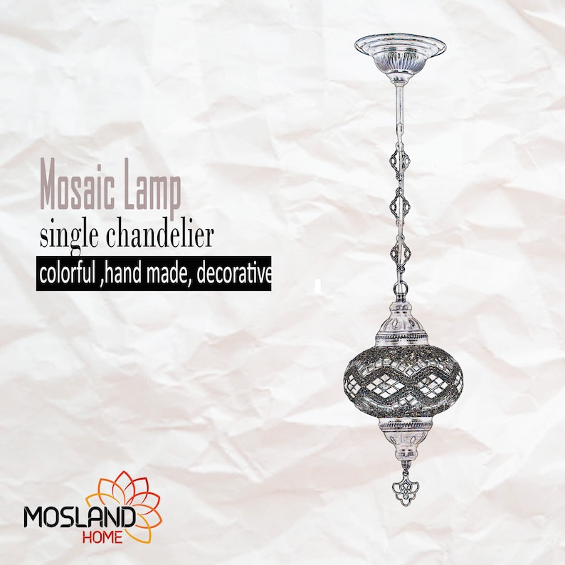 May include: A silver mosaic lamp chandelier with a chain hanging from the ceiling. The lamp has a round, glass shade with a mosaic pattern in shades of grey and white. The lamp is labelled "Mosaic Lamp single chandelier colourful, hand made, decorative".