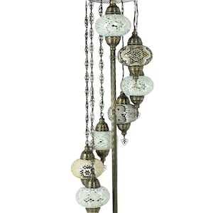 May include: A floor lamp with a spiral design and multiple mosaic glass globes. The globes are in shades of white, brown, and gold.