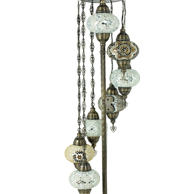 May include: A floor lamp with a spiral design and multiple mosaic glass globes. The globes are in shades of white, brown, and gold.