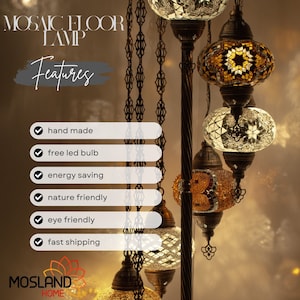 May include: A mosaic floor lamp with multiple hanging glass globes. The globes are decorated with intricate mosaic patterns in shades of gold, white, and brown. The lamp features a black metal stand and chain.