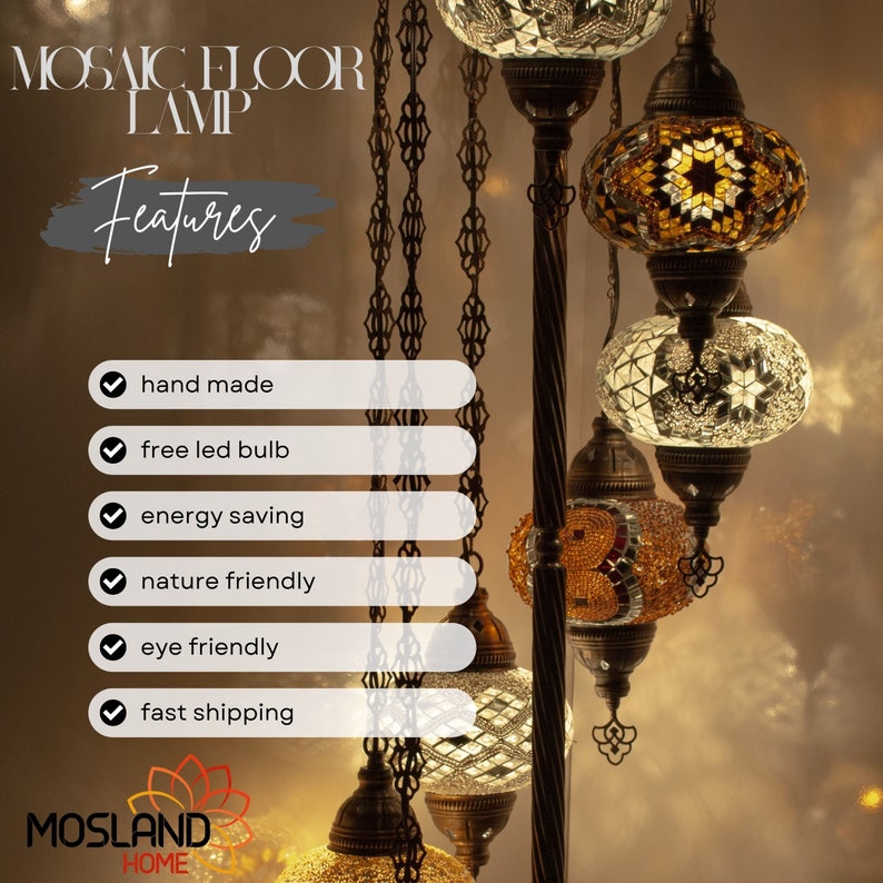May include: A mosaic floor lamp with multiple hanging glass globes. The globes are decorated with intricate mosaic patterns in shades of gold, white, and brown. The lamp features a black metal stand and chain.