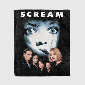 May include: A black fleece blanket with a white "SCREAM" title and a close-up image of a masked figure from the movie. The image also features the main characters from the film.