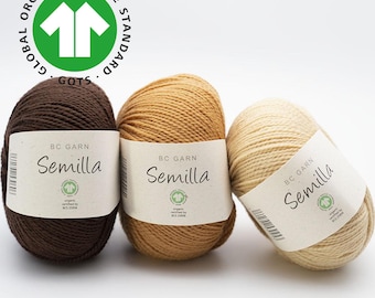 May include: Three balls of yarn in brown, beige, and cream colours. Each ball has a label that reads "BC Garn Semilla" and includes the text "organic certified by BCS 2996".