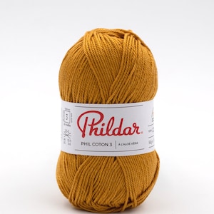 May include: A ball of mustard yellow yarn labelled "Phildar PHIL COTON 3 A L'ALOE VERA 50g e"