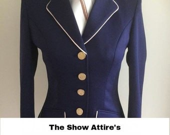 May include: A navy blue equestrian show jacket with white piping and gold buttons. The jacket is paired with a white shirt and a pink ascot. The text "The Show Attire's" is displayed on the image.
