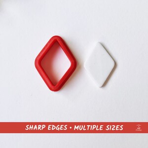 May include: A red plastic diamond-shaped cookie cutter with sharp edges and a white plastic diamond-shaped cookie.  SHARP EDGES - MULTIPLE SIZES