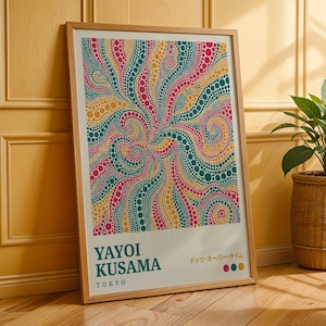 May include: A framed art print with a vibrant abstract pattern of swirling dots in teal, pink, yellow, and orange. The print includes the text "YAYOI KUSAMA TOKYO" and Japanese text. The artwork is displayed on a wooden floor.