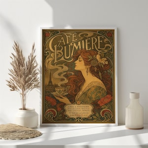 May include: A rectangular framed art print titled Cafe Lumiere featuring an illustration of a woman with long wavy hair holding a teacup. The design includes text, floral motifs, and a silhouette of the Eiffel Tower in warm earth tones.