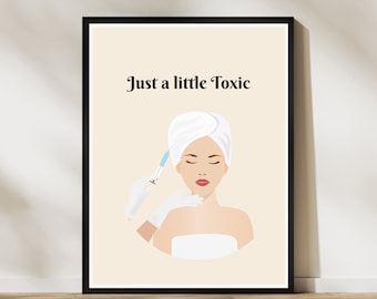 May include: A framed wall art print featuring a beige background with the text Just a little Toxic in black. The illustration shows a figure with a white head towel receiving a cosmetic injection from a gloved hand holding a blue syringe.