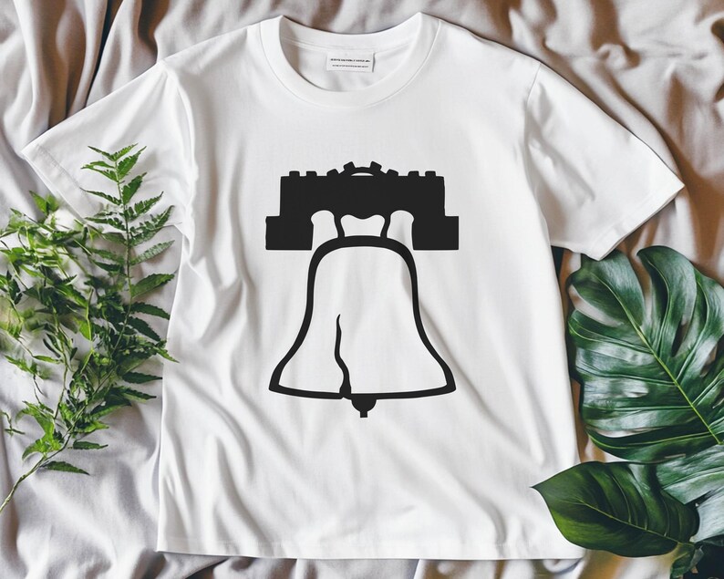 May include: White t-shirt featuring a black silhouette of the Liberty Bell and Independence Hall.