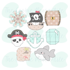Może przedstawiać: Zestaw dziewięciu foremek do ciasteczek w różnych kształtach, w tym statek piracki, skrzynia skarbów, czaszka i skrzyżowane kości, kotwica, mapa skarbów, rekin, diament i koło sterowe. Formy do ciasteczek są białe z czarnymi i czerwonymi detalami.