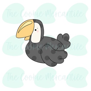 May include: A cartoon toucan with a black and white polka dot pattern and a yellow beak. The toucan is facing the right side of the image.