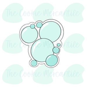 May include: A cookie cutter in the shape of a cluster of bubbles. The bubbles are outlined in black and filled with a light blue color.