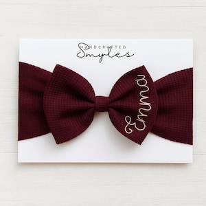 Diadema personalizada para bebé con lazo: nombre bordado, tejido de punto gofrado suave color burdeos.