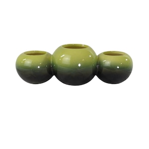 May include: A three-section ceramic planter with a green and black ombre finish. Each section is a sphere with a rounded opening at the top.
