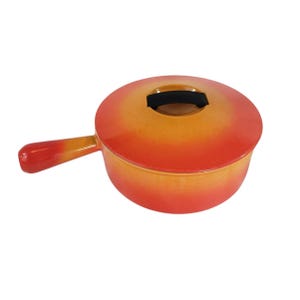 May include: Orange and yellow enameled cast iron fondue pot with a black handle on the lid.