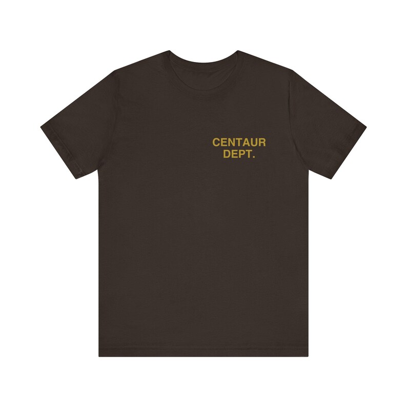 May include: A dark brown t-shirt with the text "CENTAUR DEPT." printed in gold on the upper chest area. The shirt has short sleeves and a crew neck.