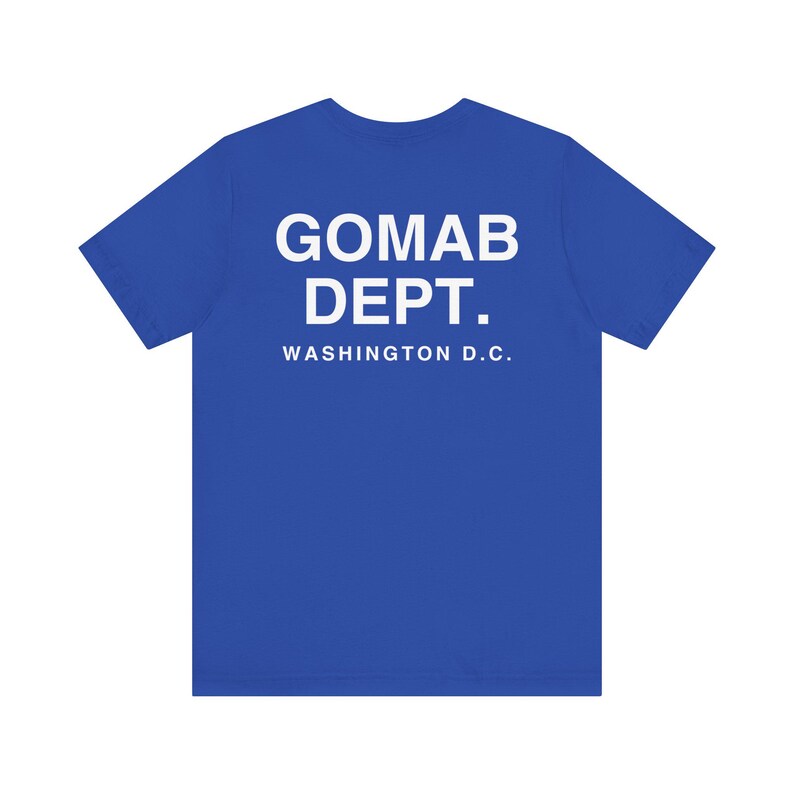 May include: A royal blue t-shirt with the text "GOMAB DEPT. WASHINGTON D.C." printed in white. The shirt is a crew neck style and appears to be made of a soft, comfortable material.