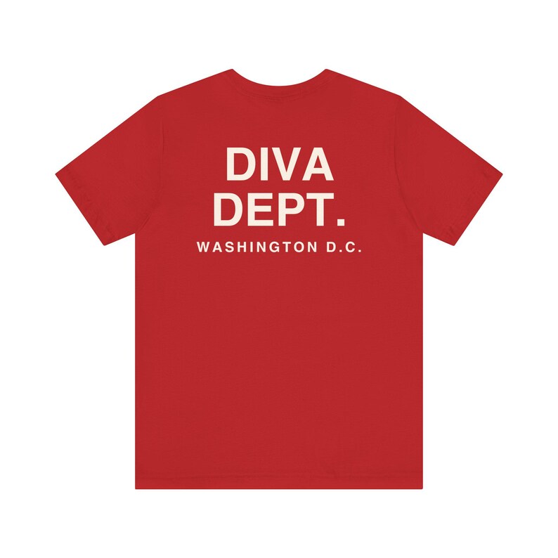 May include: A red t-shirt with the text "DIVA DEPT." and "WASHINGTON D.C." printed in white. The shirt is a short-sleeved crew neck style.