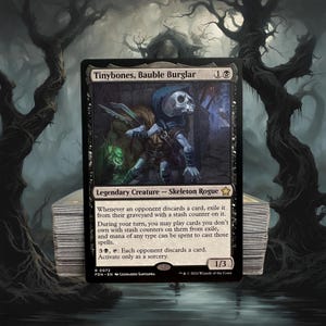 May include: A Magic: The Gathering card featuring "Tinybones, Bauble Burglar," a Skeleton Rogue. The card has a black border with a detailed illustration of the character. The card text describes its abilities. A stack of cards is visible in the foreground.