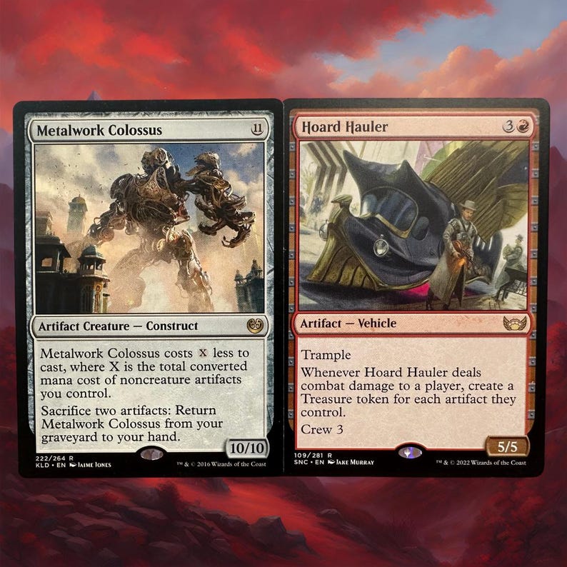 May include: Two Magic: The Gathering cards, one depicting a large, metallic robot with a red background and the other depicting a flying vehicle with a red and gold background. The text on the cards reads "Metalwork Colossus" and "Hoard Hauler".