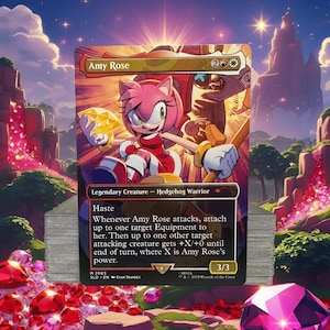 May include: A collectible trading card featuring Amy Rose, a pink hedgehog character, holding a golden gem. The card has a red and gold design with the text "Amy Rose" and "Legendary Creature - Hedgehog Warrior". The card is part of a stack.