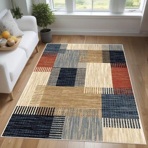May include: A beige, blue, red and brown geometric patterned area rug with a modern design.
