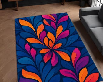 May include: A blue rug with a floral pattern in shades of orange, pink, and purple. The rug has a modern design and would add a pop of color to any room.