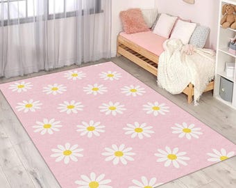 May include: A pink rug with a white daisy pattern. The daisies have yellow centres.