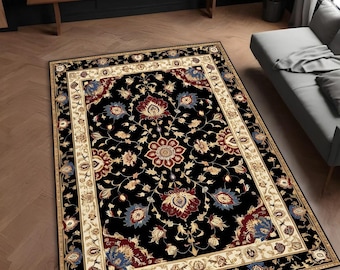 May include: Black and cream area rug with a floral pattern. The rug has a detailed border with a repeating pattern of leaves and flowers.
