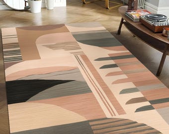 May include: Abstract geometric rug with a beige background and brown, gray, and black geometric shapes. The rug has a modern design and would be a great addition to any living room or bedroom.
