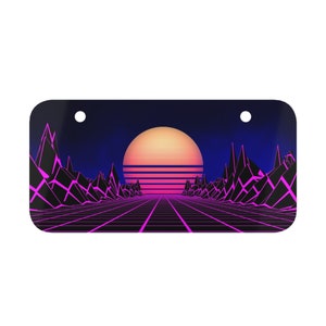 May include: A retro-style sunset scene with a pink and orange sun over a gridded road and black mountains. The background is a dark blue.