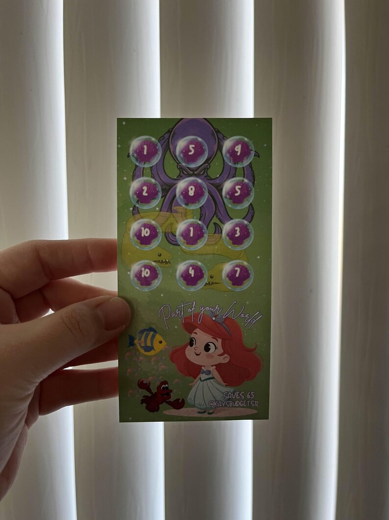 May include: A green card featuring a cartoon octopus and bubbles with numbers. Below, a cartoon mermaid and crab are depicted. The text "Part of your World" and "SAVES 65" are also visible on the card.