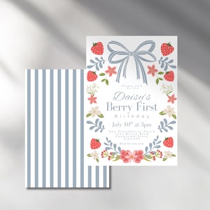 May include: A white invitation with a blue bow and red strawberries, flowers, and leaves. The text reads "Please join us for Daisy's Berry First Birthday July 10th at 3pm The Strawberry Patch Yourtown State Zipcode Rev 555-555-5555".