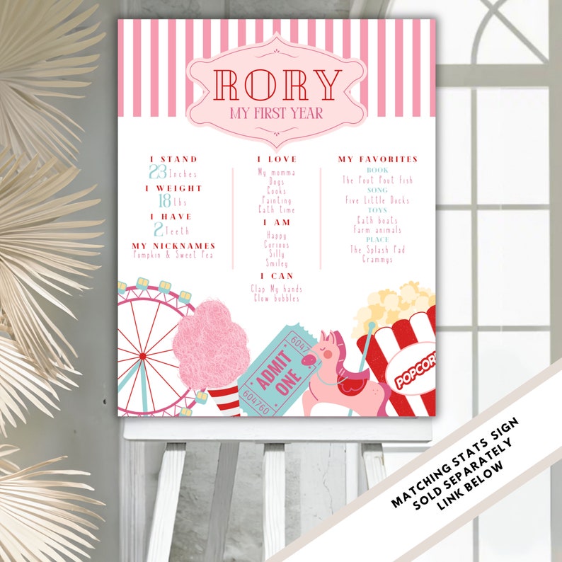 May include: A pink and white striped printable poster with a carnival theme. The poster says "RORY MY FIRST YEAR" and lists the child's stats, favorites, and what they can do. The poster features illustrations of a Ferris wheel, cotton candy, a carousel horse, and popcorn.