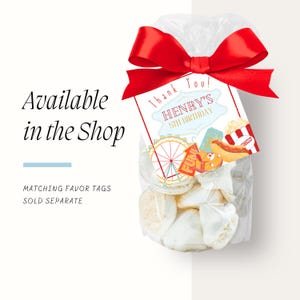 May include: A clear cellophane bag tied with a red satin bow, filled with white treats. A tag reads "Thank You! HENRY'S 5TH BIRTHDAY" with carnival-themed graphics. Text on the left says "Available in the Shop".