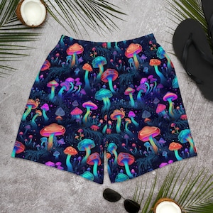 May include: Neon-colored mushroom print men's swim trunks with a dark blue background. The mushrooms are in various shades of pink, blue, green, and orange.