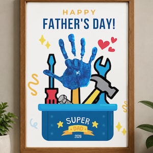May include: A framed print featuring the text HAPPY FATHER'S DAY! at the top and a blue handprint centered above a blue toolbox illustration. The toolbox contains various tools and is labeled SUPER DAD 2026. The design includes yellow stars, red hearts, and yellow squiggles.