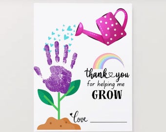 May include: A white card with a purple handprint forming a flower, watered by a pink watering can. The text reads "thank you for helping me GROW" with a rainbow and hearts.