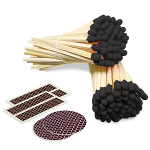 May include: A bundle of 100 long wooden matches with black tips. The matches are tied together with a white string. There are also two rectangular and two round strike pads with a honeycomb pattern.
