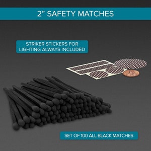 May include: A set of 100 black safety matches, 2 inches long, with round black heads. The matches are arranged in a pile. The image also shows striker stickers for lighting, which are always included.