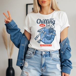 May include: A set of three ceramic mugs with a speckled, matte finish. The mugs are in shades of cream, light gray, and dark gray. Each mug has a simple, minimalist design and a rounded handle.