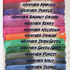 May include: A stack of fabric swatches in various shades of heather, including pitch black mist, dark heather, heather red, heather maroon, heather purple, heather radiant orchid, heather berry, heather heliconia, heather orange, heather irish green, heather green grass, heather forest, heather navy, heather indigo, heather galapagos blue, and heather sapphire.