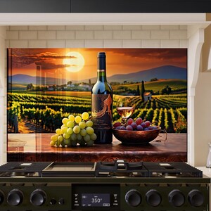 May include: A kitchen backsplash featuring a sunset over a vineyard scene. A bottle of red wine, a glass of wine, grapes, and a bowl of grapes are on a wooden countertop in front of the backsplash.