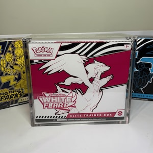 May include: A Pokémon Scarlet & Violet White Flare Elite Trainer Box. The box is white and magenta with a white illustration of a Pokémon. The box has the Pokémon Trading Card Game logo and the text "Elite Trainer Box".