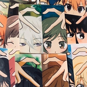 May include: A collage of anime character stickers featuring a heart shape made with their fingers. The stickers depict characters with various hair colours and styles, including white, brown, and green. The stickers display the text "SARANIME" on them.